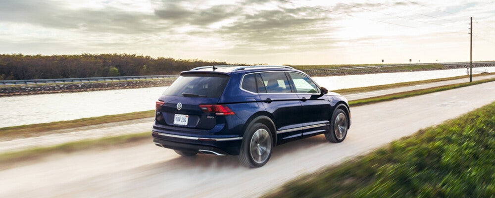 a volkswagen tiguan going very fast through the countryside
