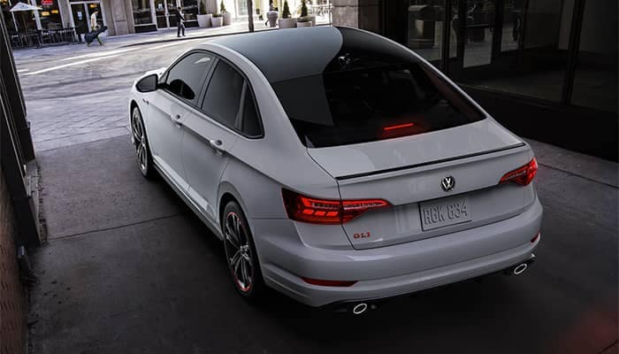 silver jetta gli pulling out of an alley