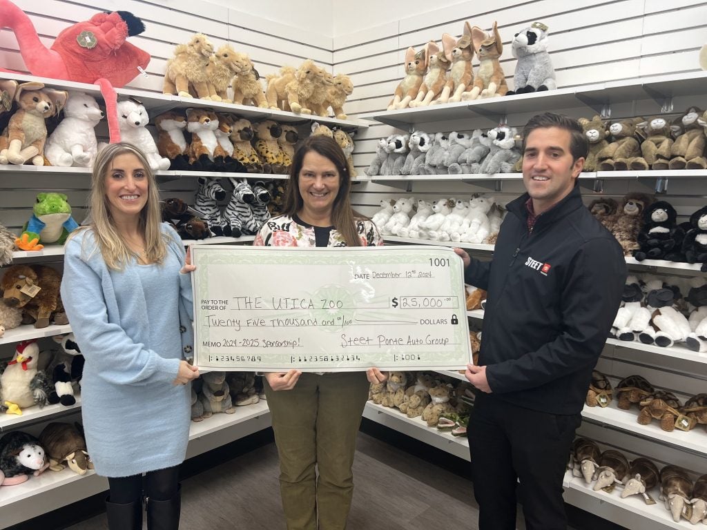 Carly Steet Mathias, left; Andria Heath, Utica Zoo Director, middle; Joe Steet Jr., right, presenting their $25,000 donation to the. Utica Zoo