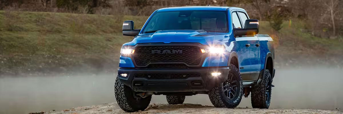 Blue 2026 Ram 1500 Rebel Crew Cab Parked on a Small Hill