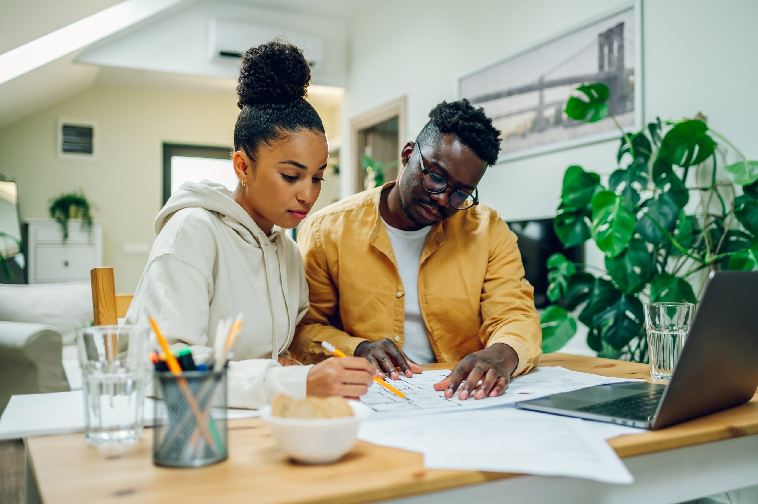 Portrait,Of,A,Diverse,Couple,Sitting,At,The,Table,At