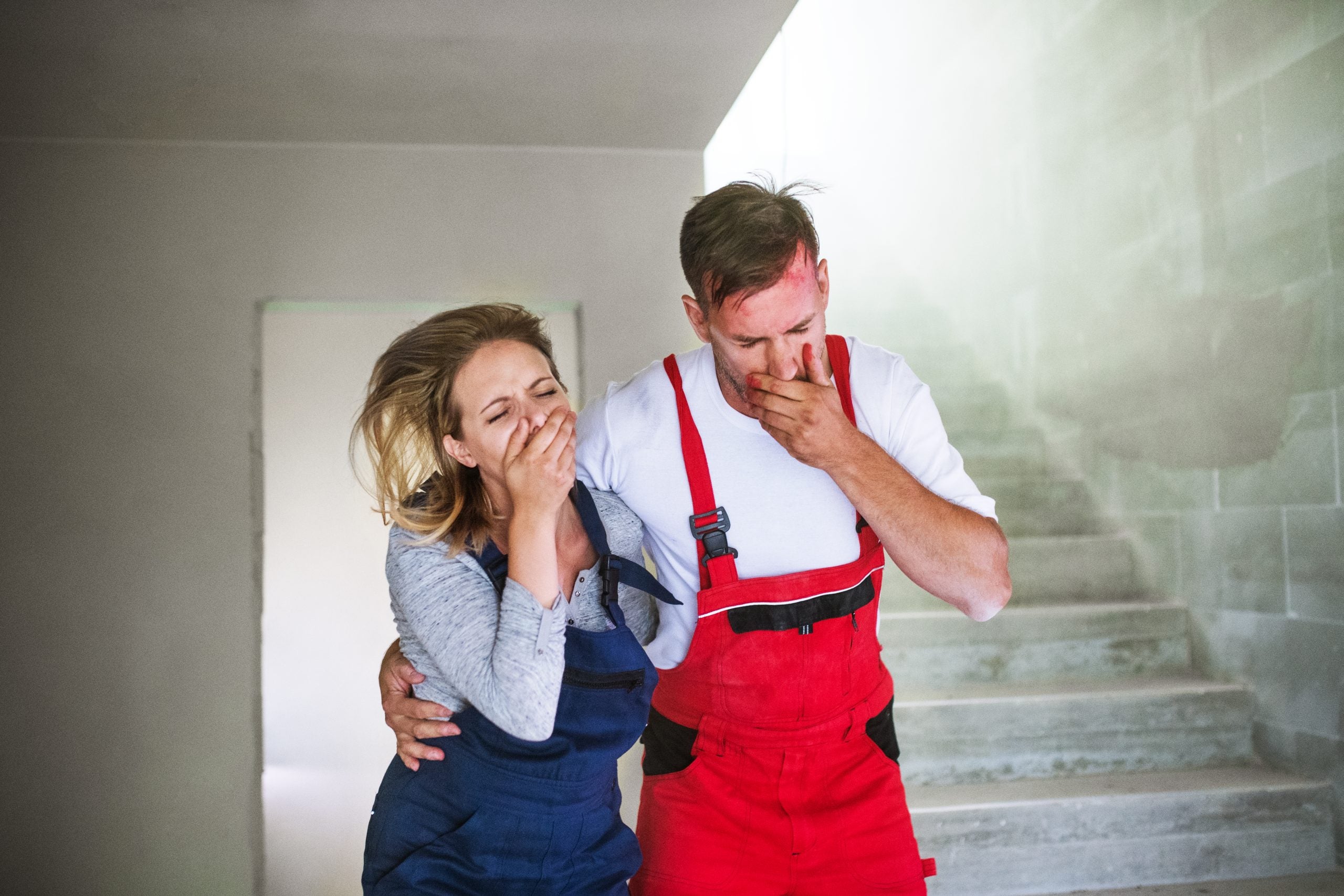 Woman,And,Man,Workers,Suffocating,At,The,Construction,Site.
