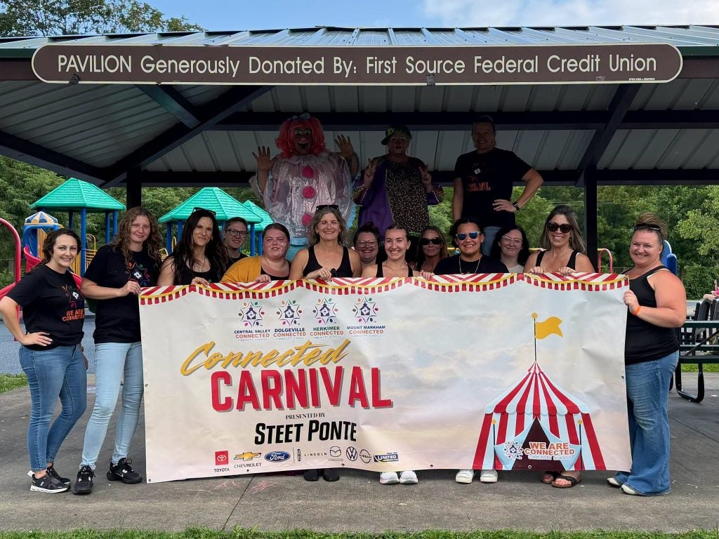 Connected Community Schools Team with Carnival Banner
