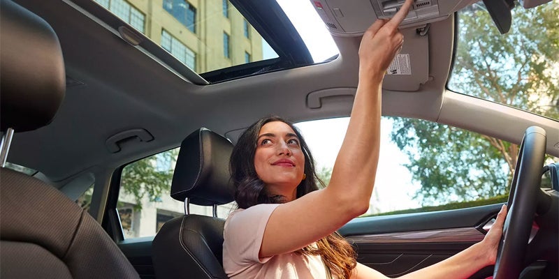 A woman driving a 2024 VW Jetta.