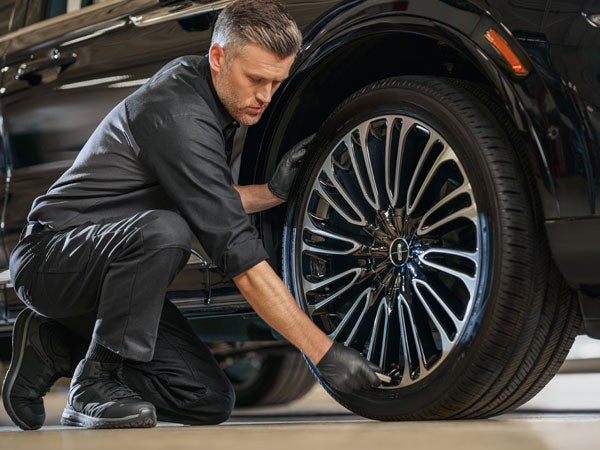 Lincoln Service Tech Checking Tire Pressure