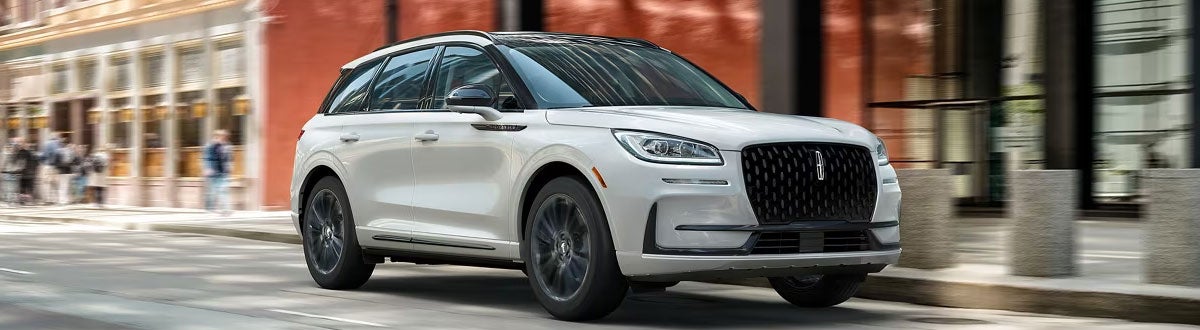 White Lincoln Corsair SUV Driving in the City