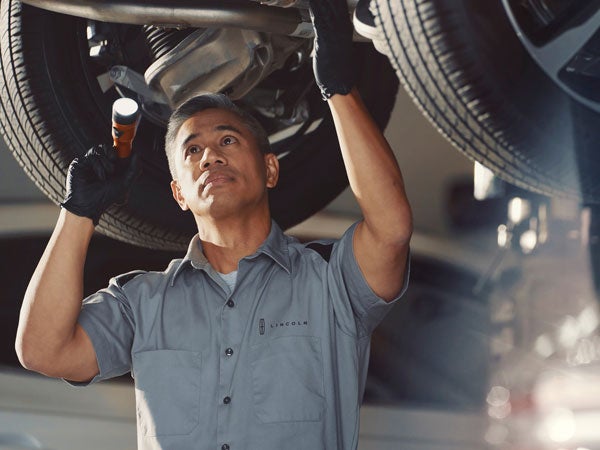 Lincoln Service Tech Inspecting Vehicle