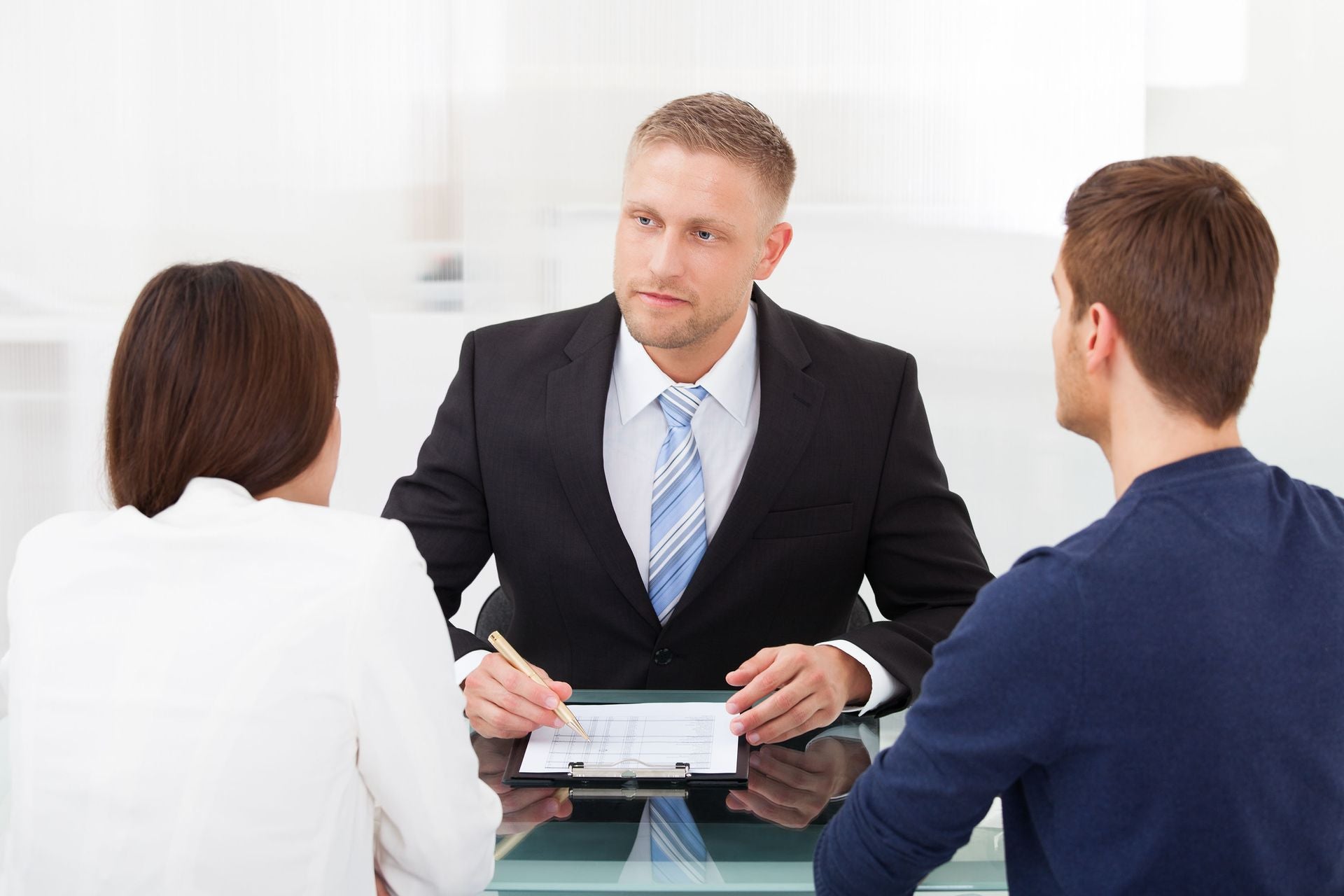 a couple sits in front of a lawyer