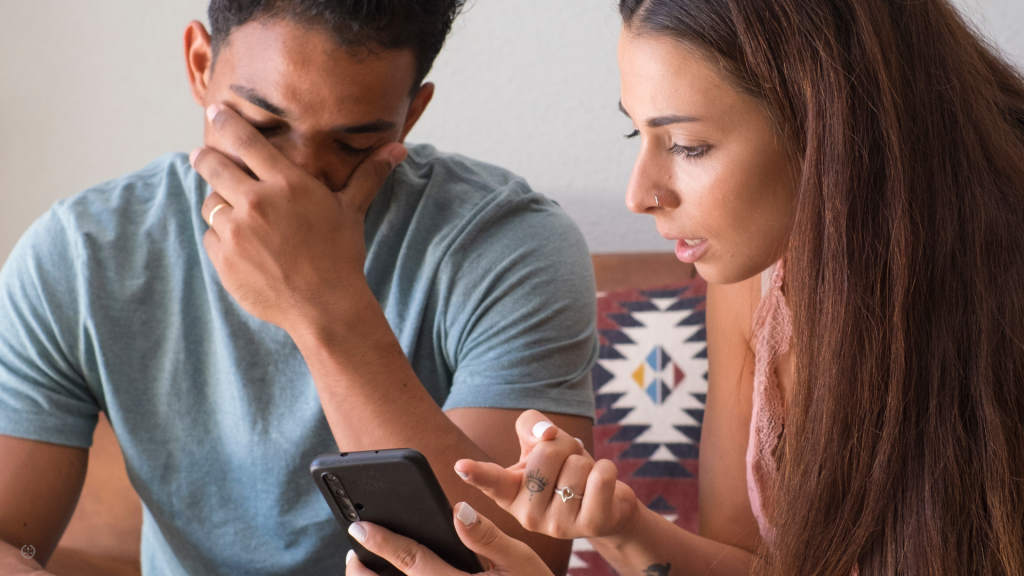 A couple discusses a text that was found on the husbands phone.