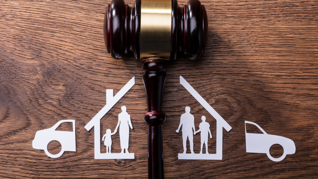 A gavel splits a paper cutout of a family