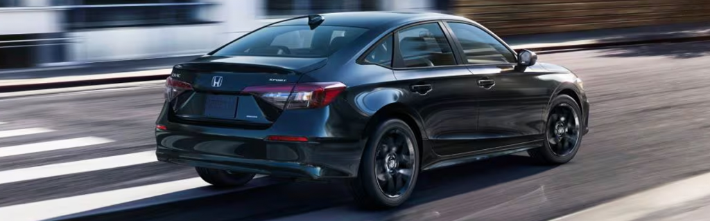 2026 Black Honda Civic Sedan driving on city street.