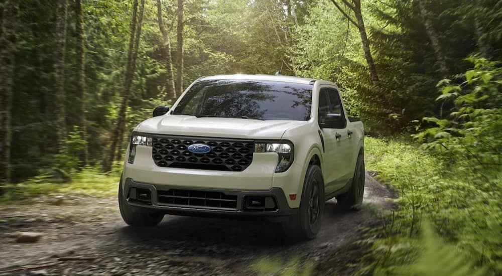 A white 2025 Ford Maverick XLT off-roading.