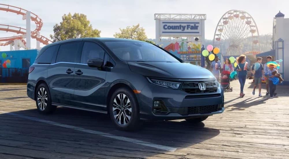 A gray 2026 Honda Odyssey for sale parked near a fair.