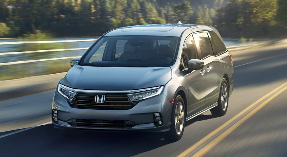 A silver 2025 Honda Odyssey driving on a highway.