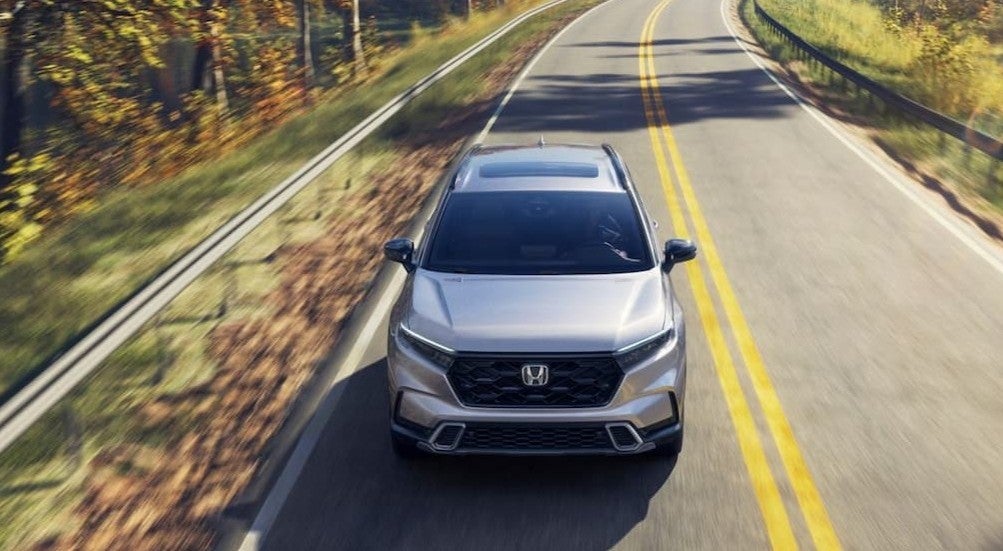 A silver 2026 Honda CR-V driving on a highway.