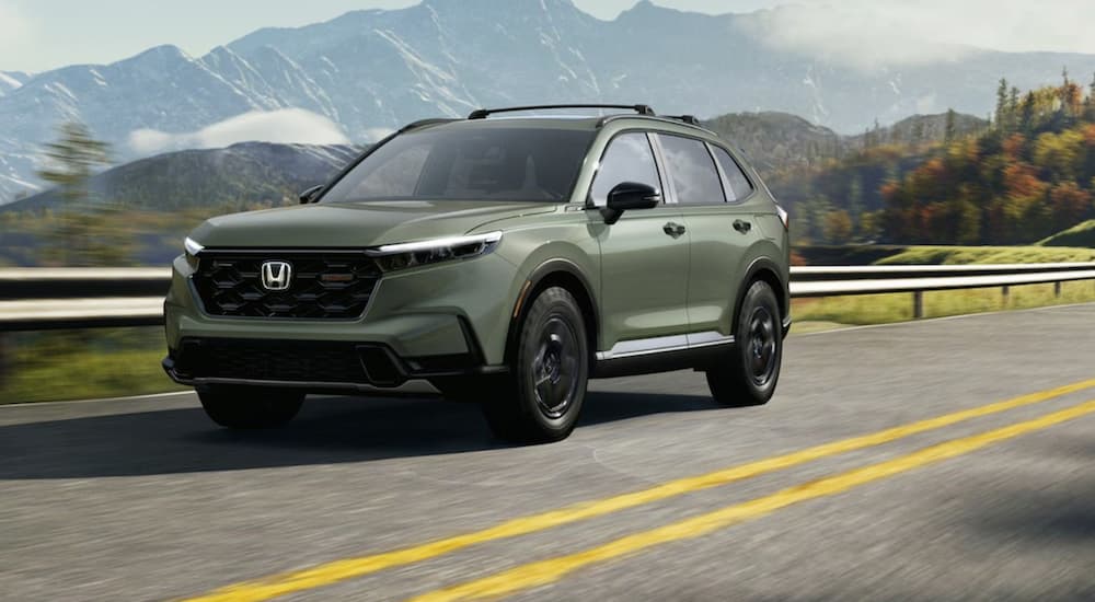 A green 2026 Honda CR-V TrailSport for sale driving down a road