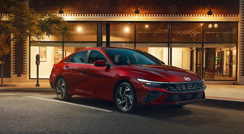 A red 2026 Hyundai Elantra parked in a city.