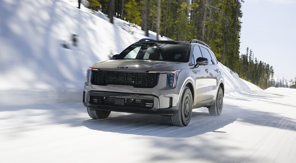 Grey 2026 Kia Sorento X-Pro SX Prestige for sale driving down a snowy road.