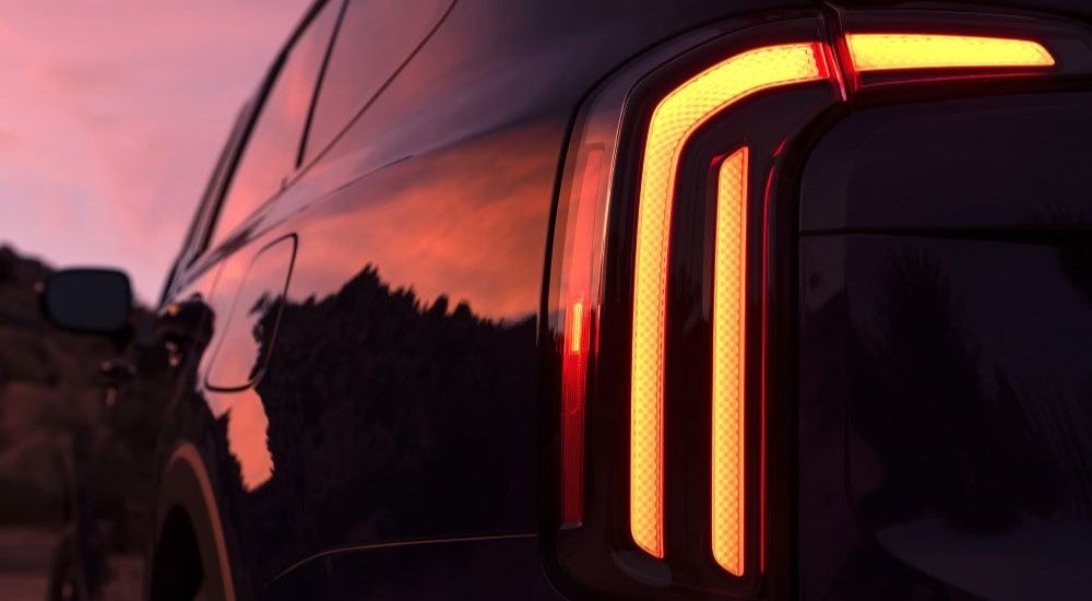Close-up on the taillight of a black 2025 Kia Telluride.