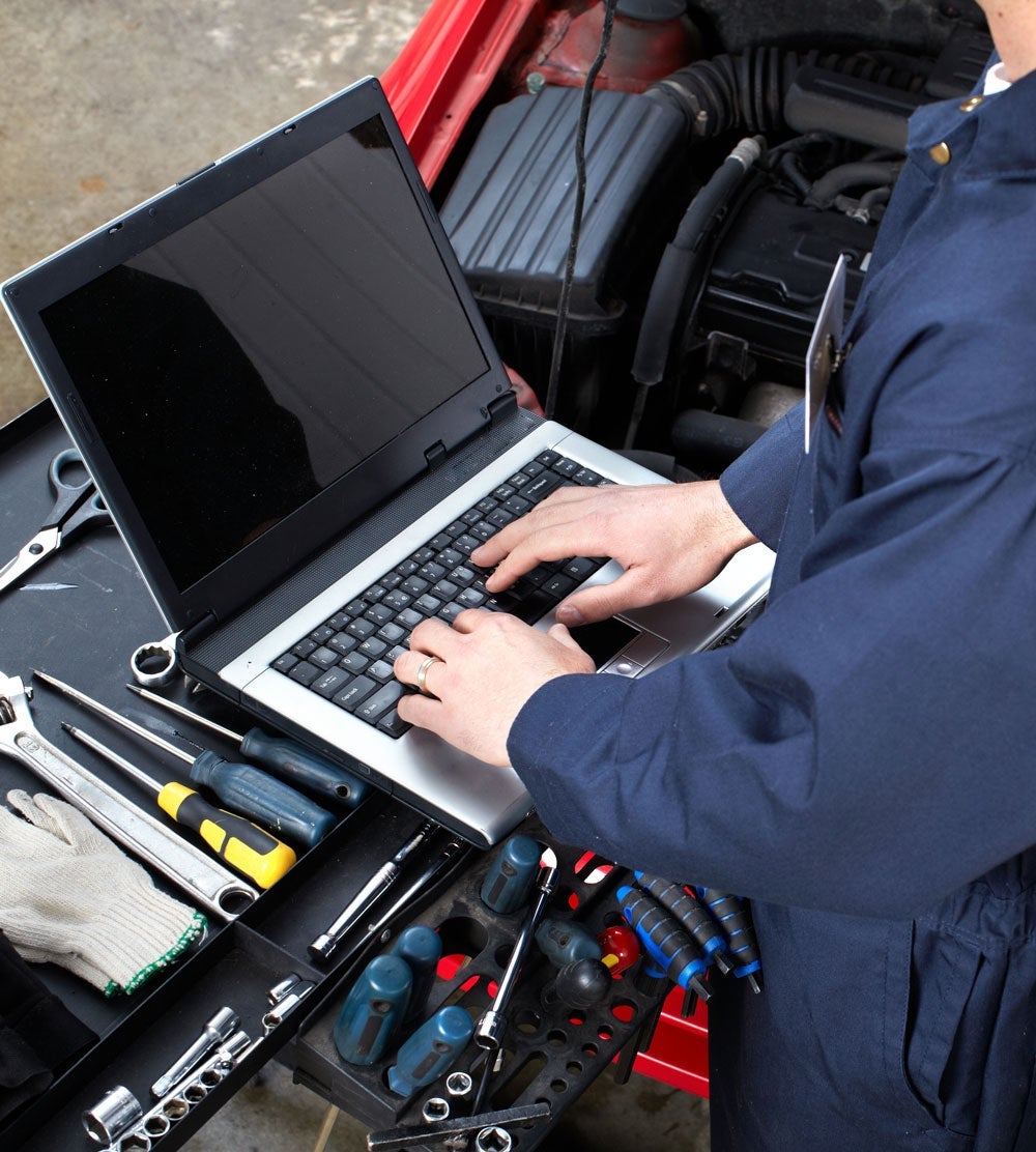 Service tech using a laptop