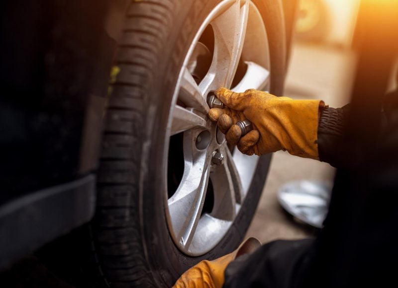 A person removing a tire