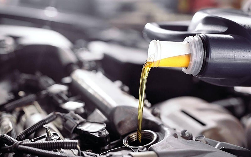 oil being poured into vehicle