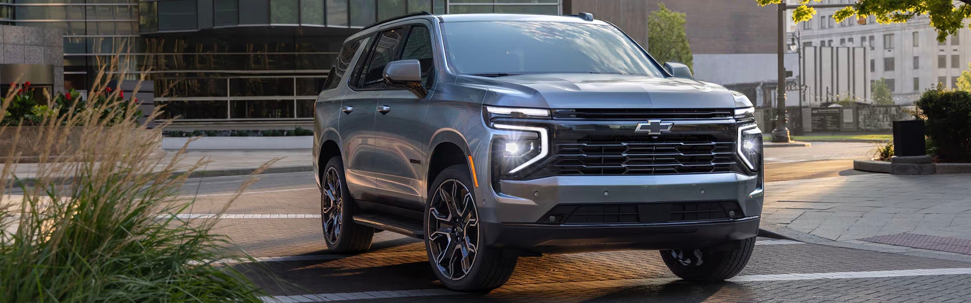 2025 Chevrolet Tahoe for sale in Concord, NC – front view of silver SUV with bold grille, LED headlights, and modern design.