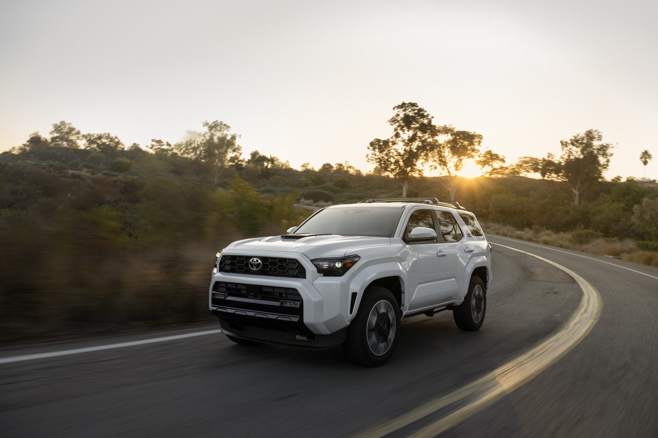 Toyota 4Runner in white driving on road