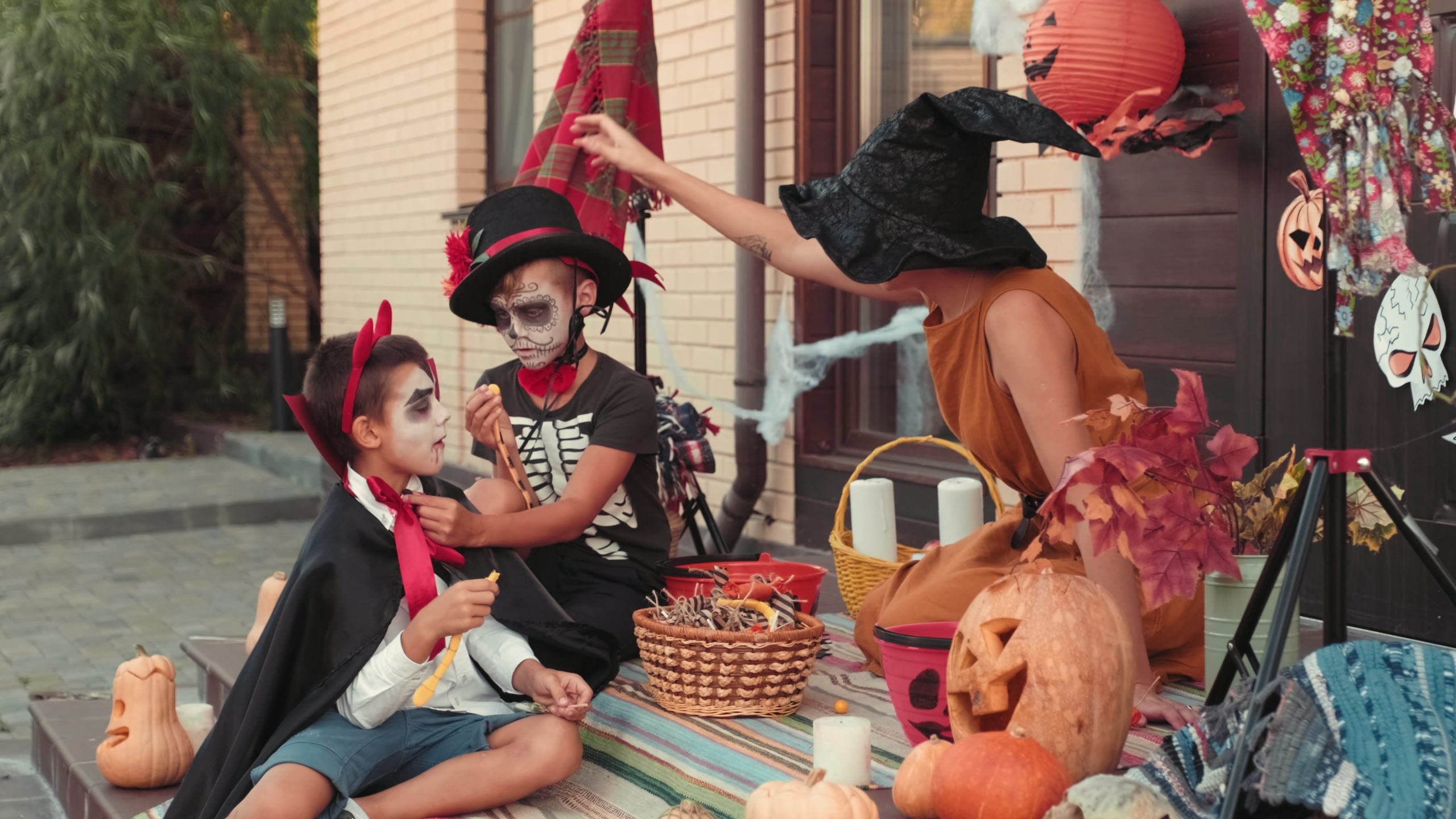 children sitting on a porch with candy