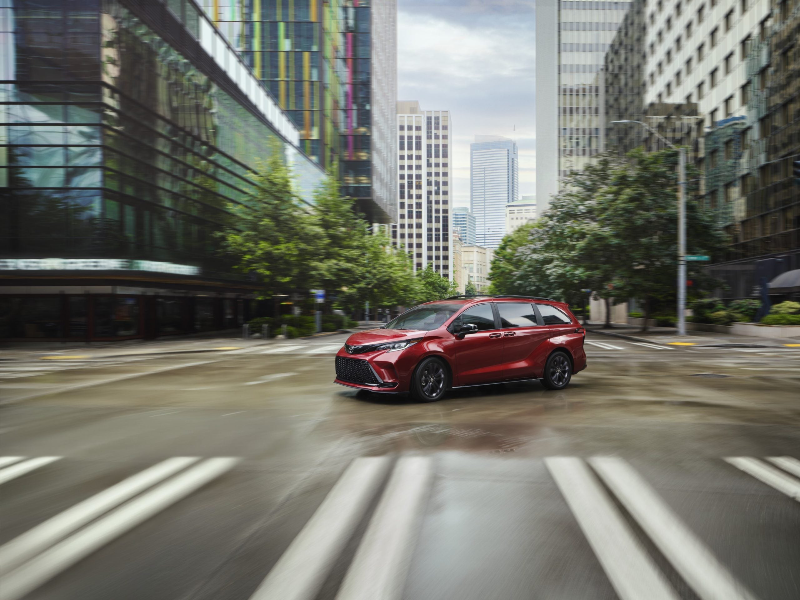 2026 Toyota Sienna in red driving around the city
