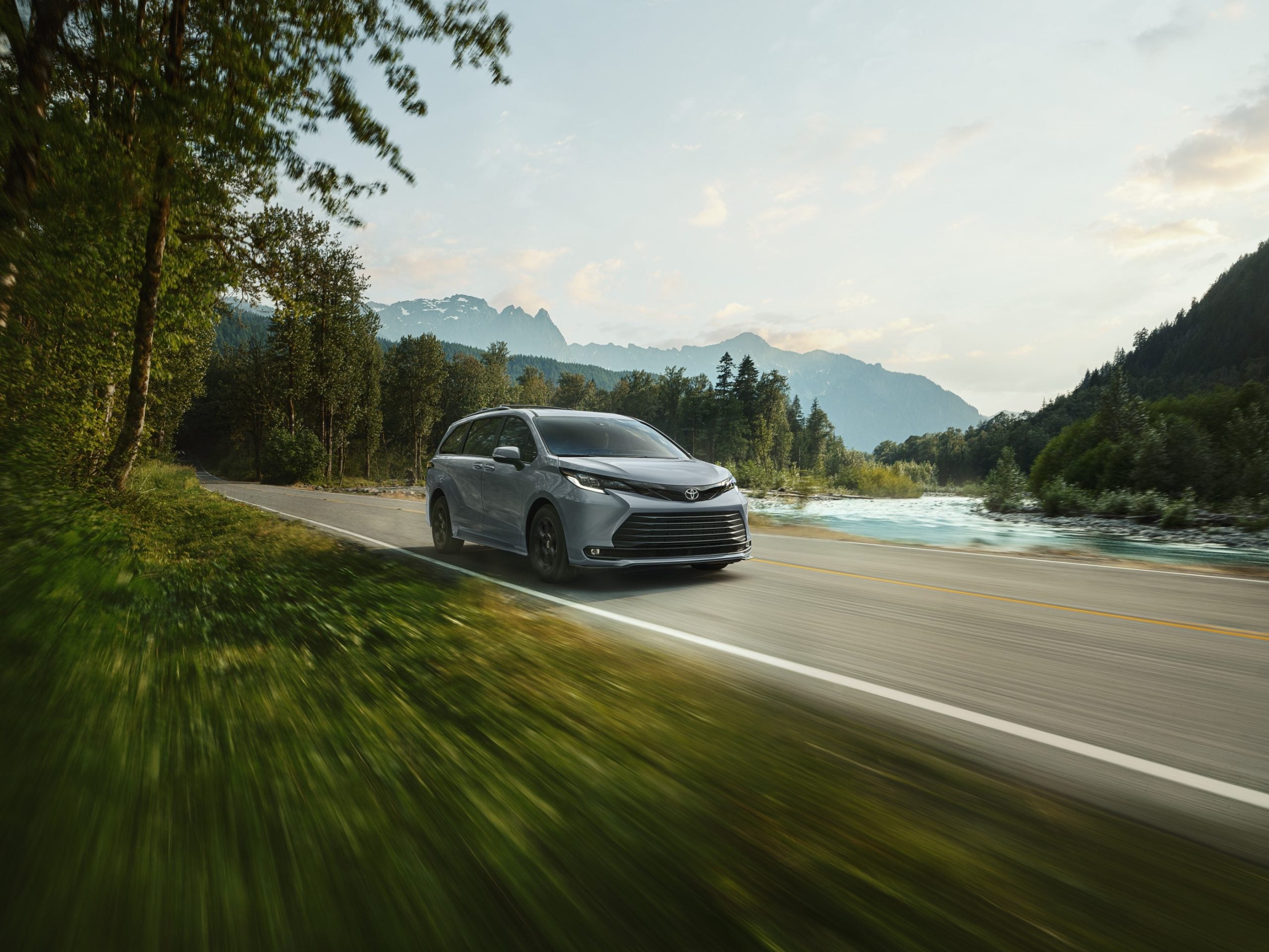 2026 Toyota Sienna driving through a scenic background