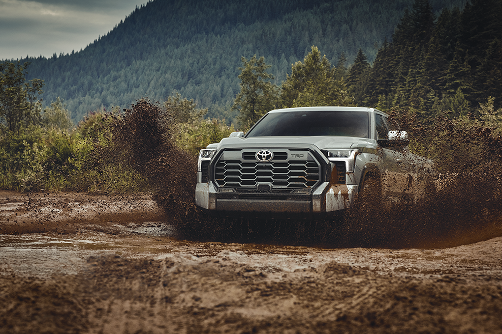 Toyota Tundra driving through a muddy terrain
