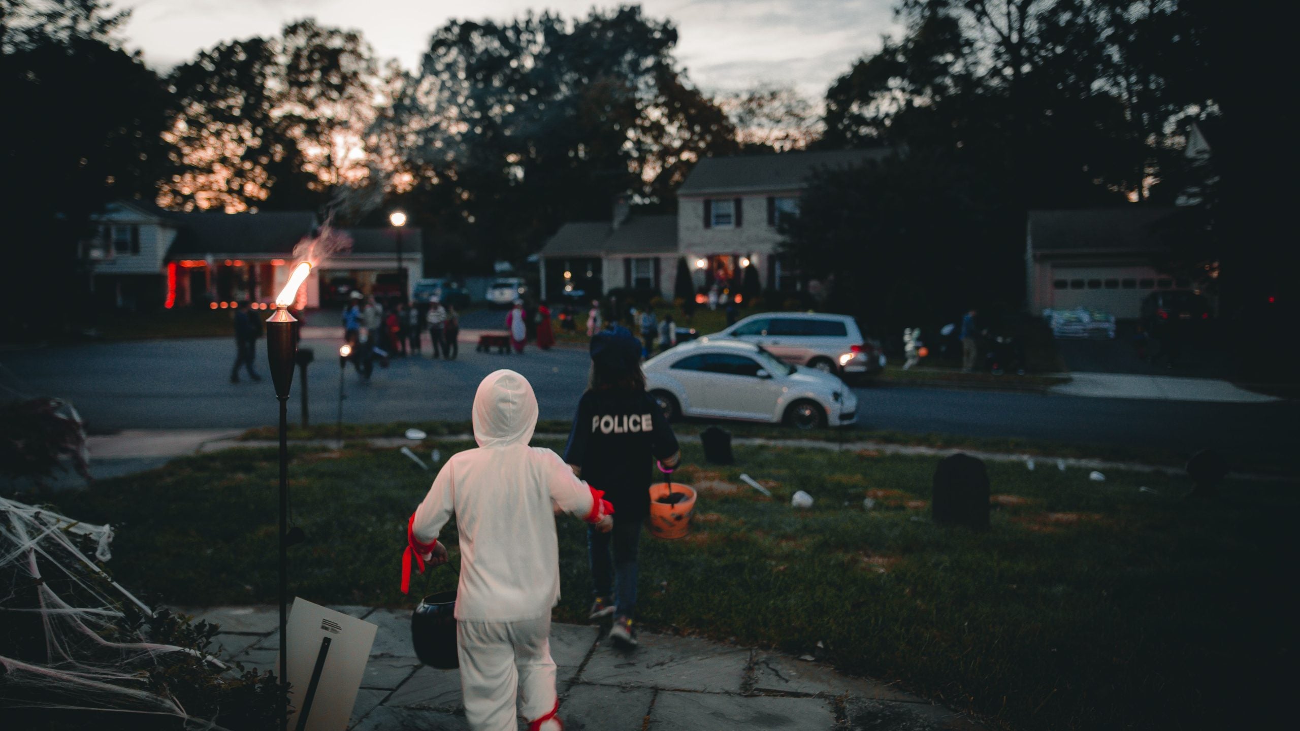 kids trick or treating in a neighborhood