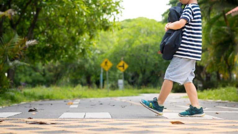 A child walks over a crosswalk