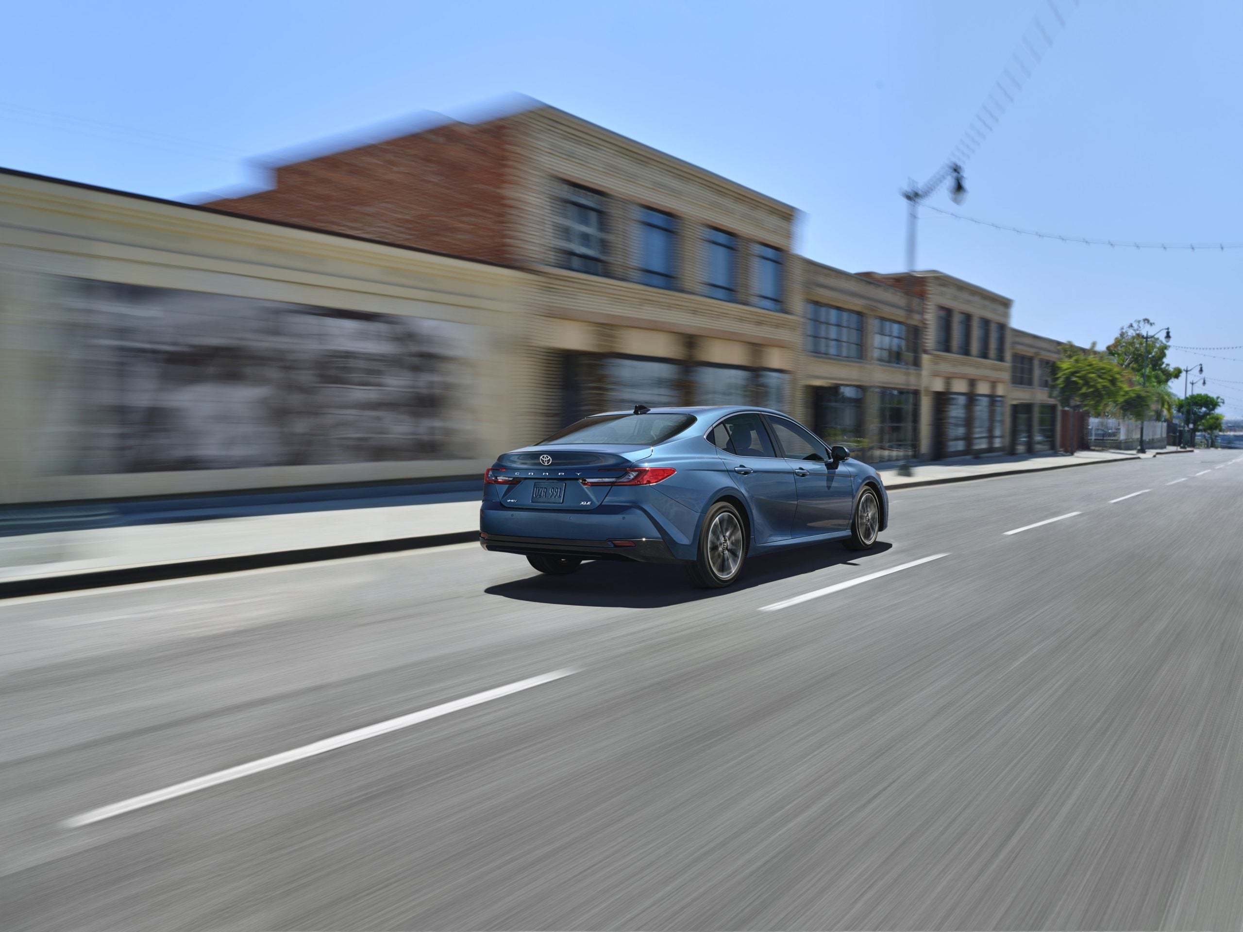 2026 Toyota Camry driving through city showcasing smooth performance