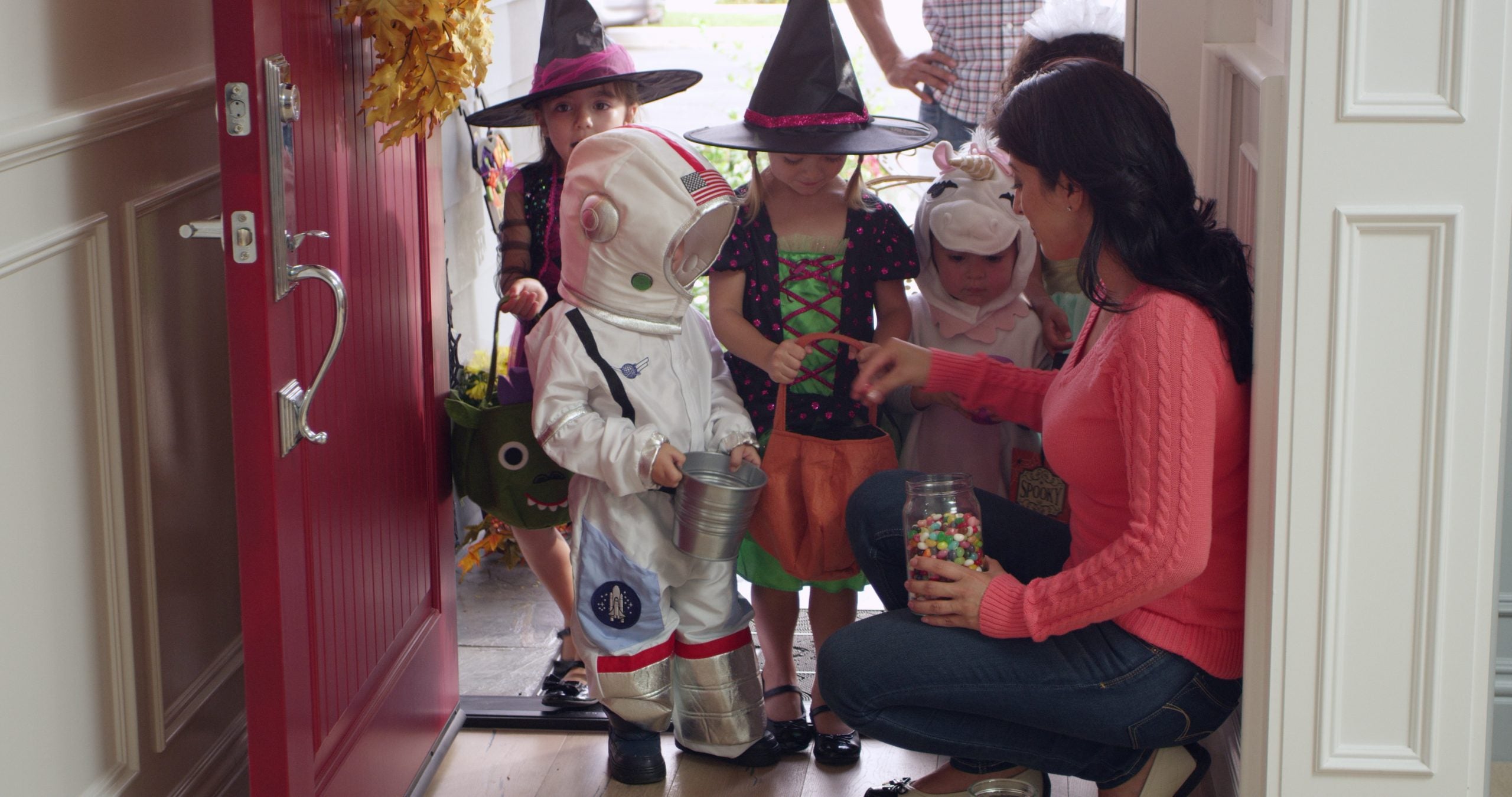 Kids standing in a door way getting candy
