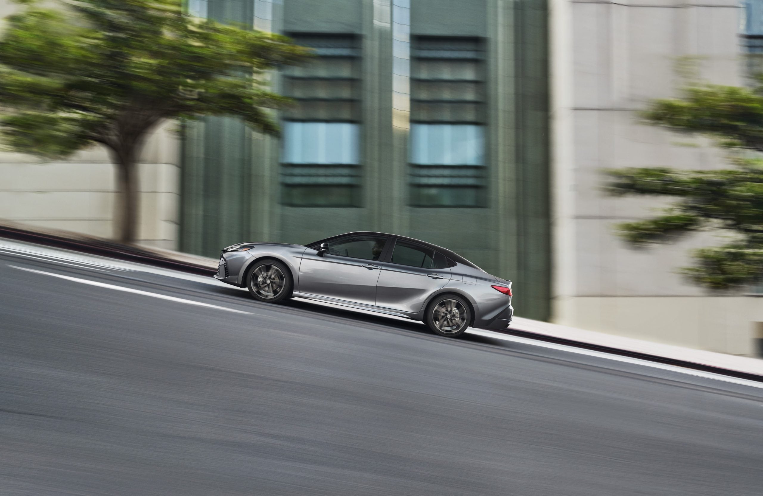 2026 Toyota Camry in silver driving up hill highlighting performance and handling