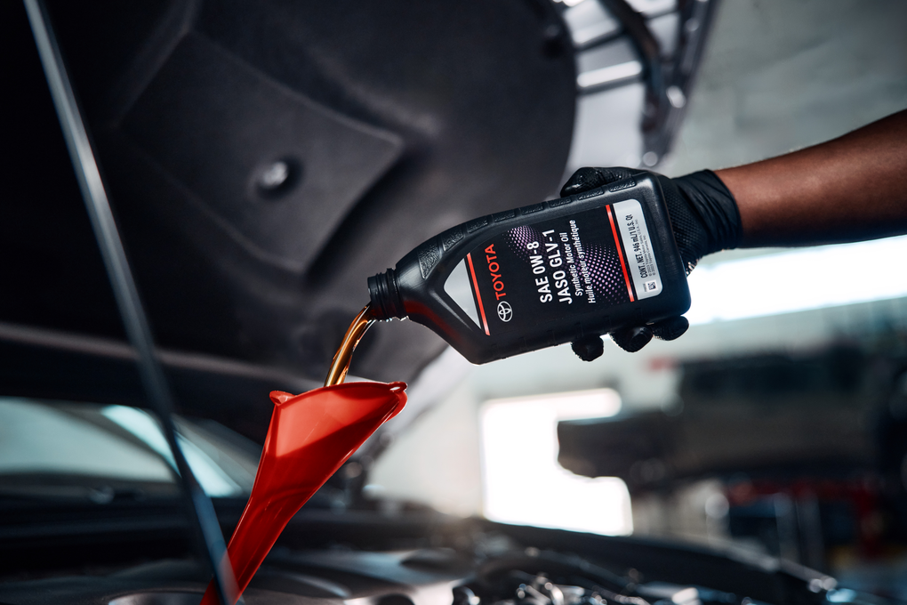 Close up shot of someone pouring engine oil