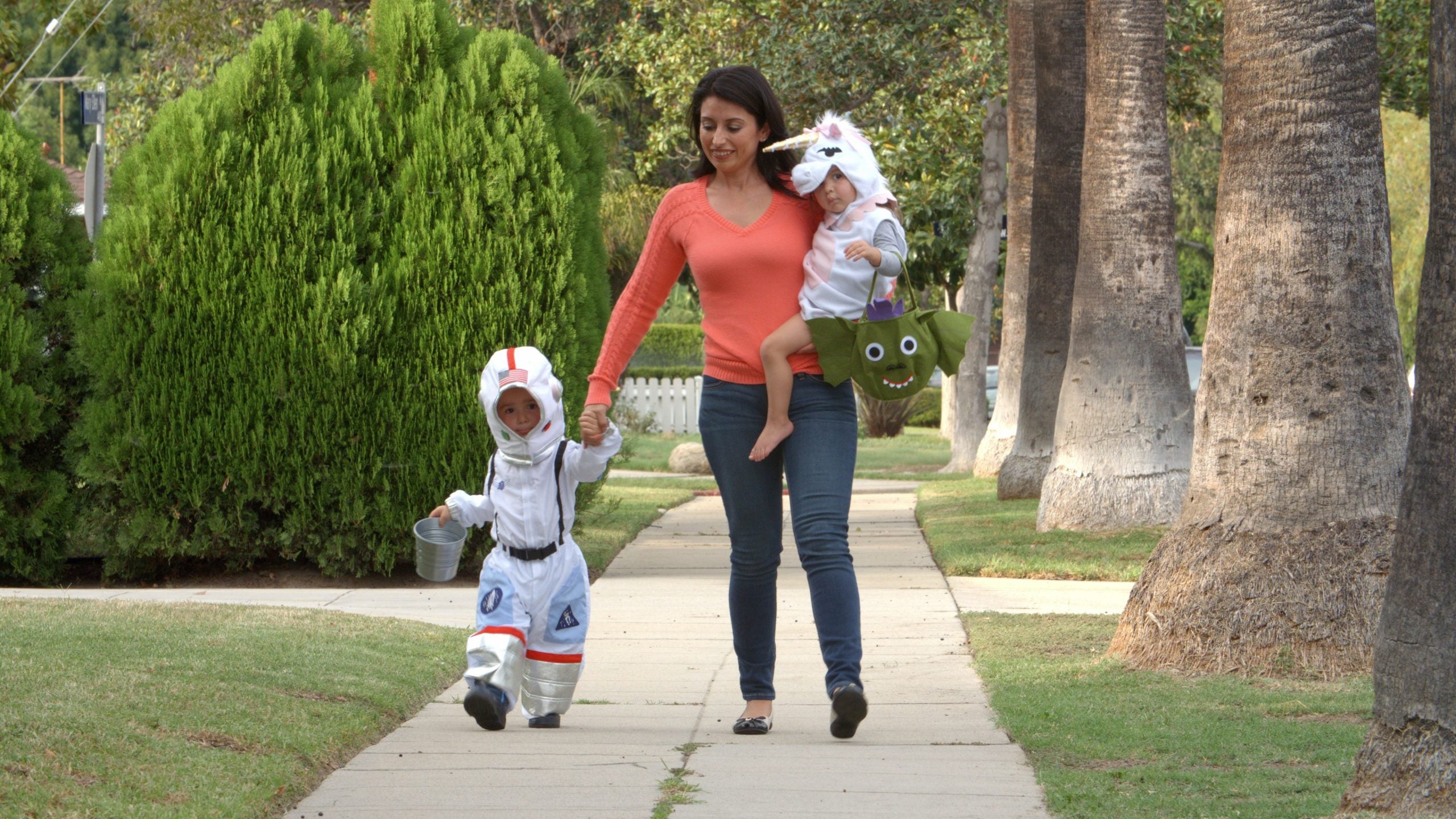 a mother with her children trick or treating