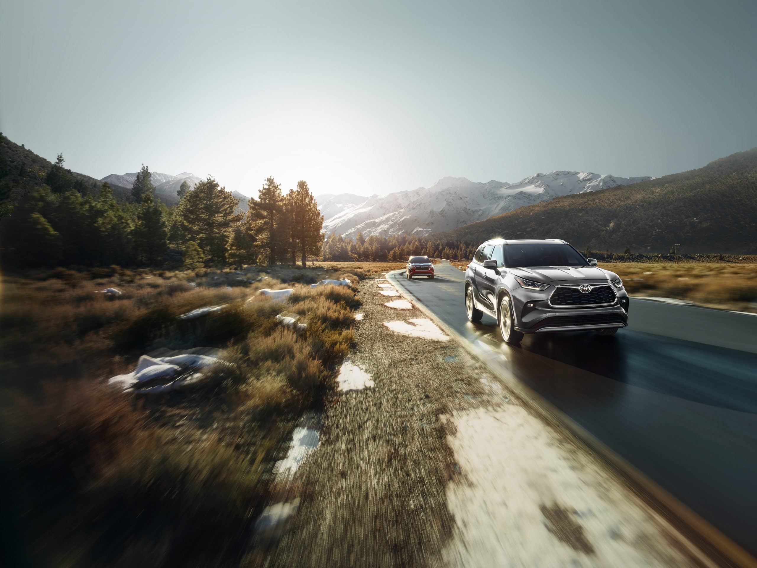 2026 Toyota Highlander driving through the snowy mountains