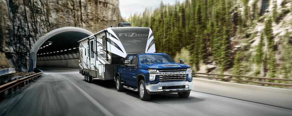 Blue Chevy Silverado 3500 towing an RV