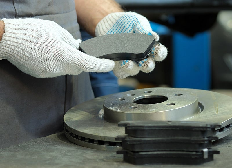 mechanic changing brake pads