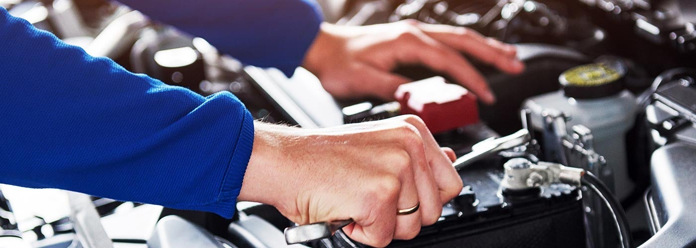 tech working on car battery