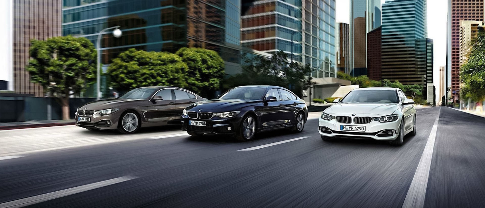 BMW sedans driving