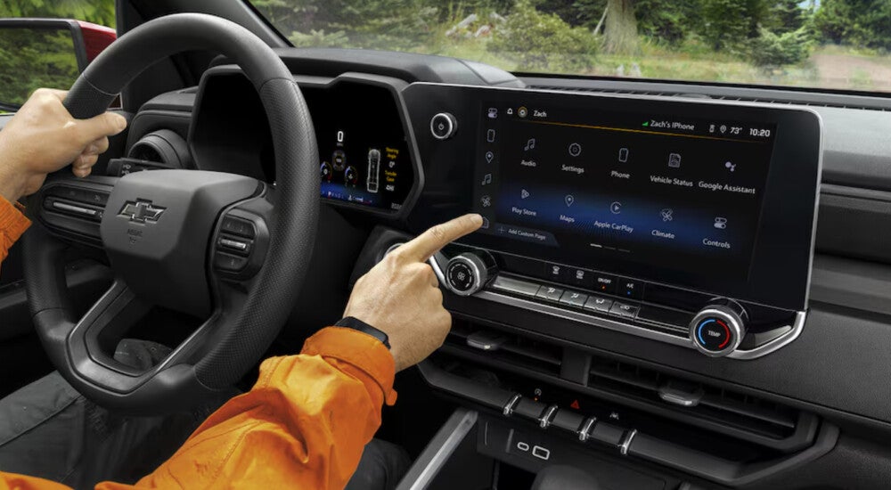 Pointing to interior screen of 2024 Chevrolet Colorado