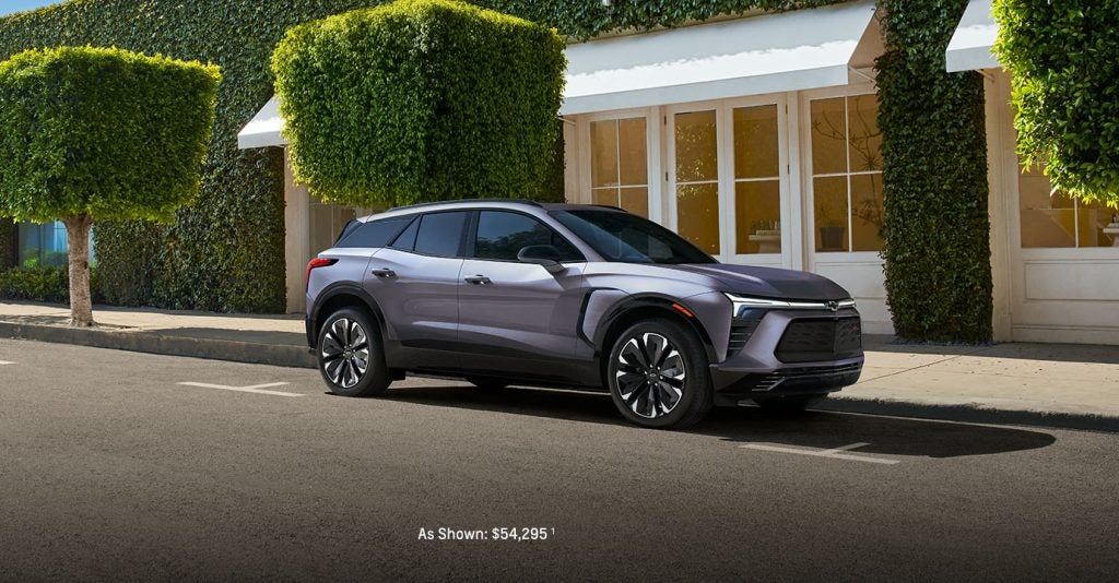 A silver 2025 Chevy Blazer EV parked on a city street near Seminole Chevrolet GMC, showcasing its modern design and electric styling.