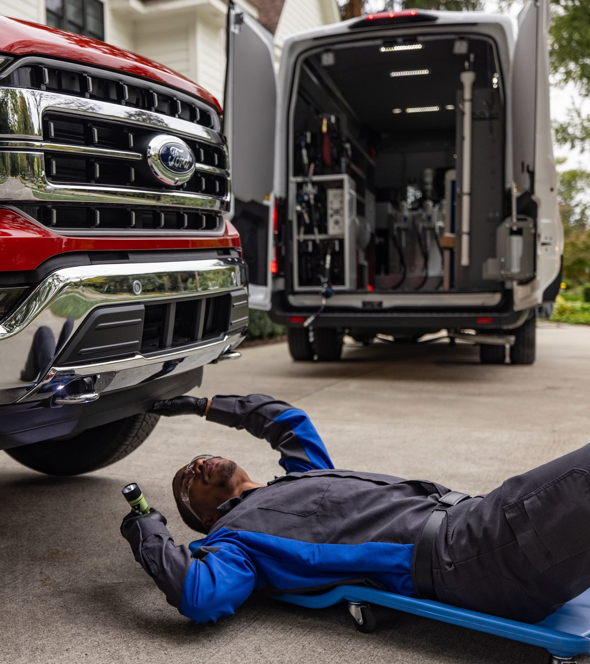 mechanic working under a ford pickup truck