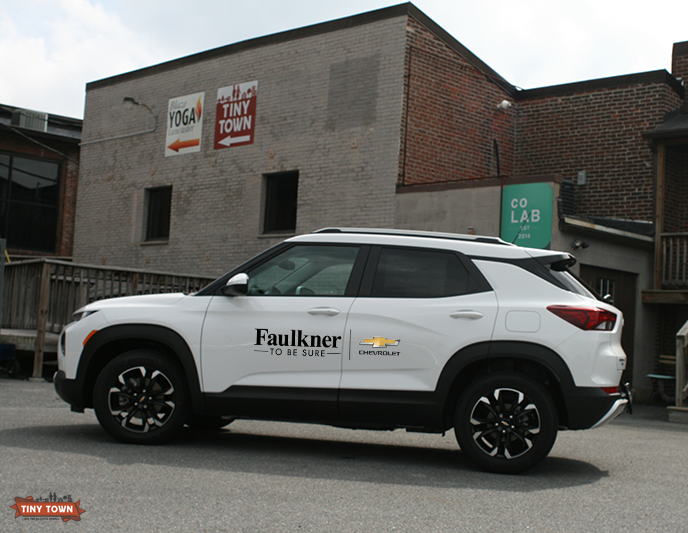 a white suv with the faulkner chevrolet logo on its doors