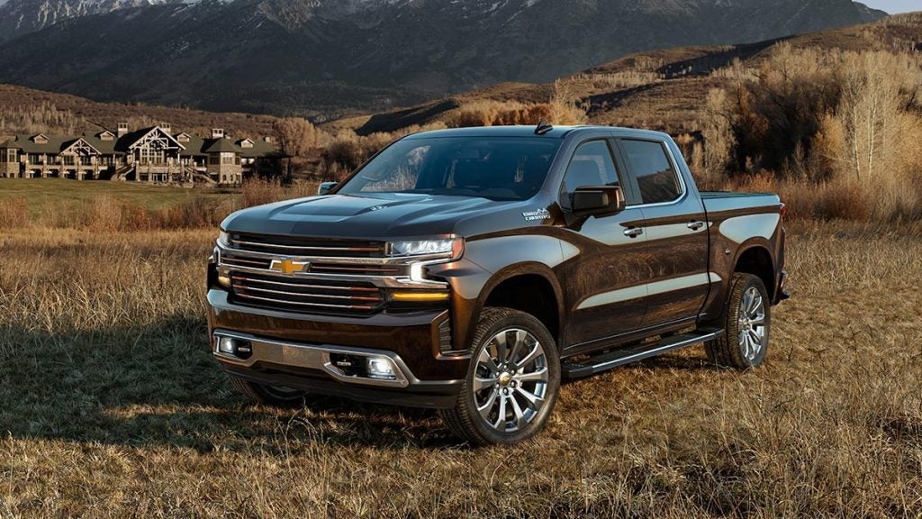 grey truck parked in a grassy area