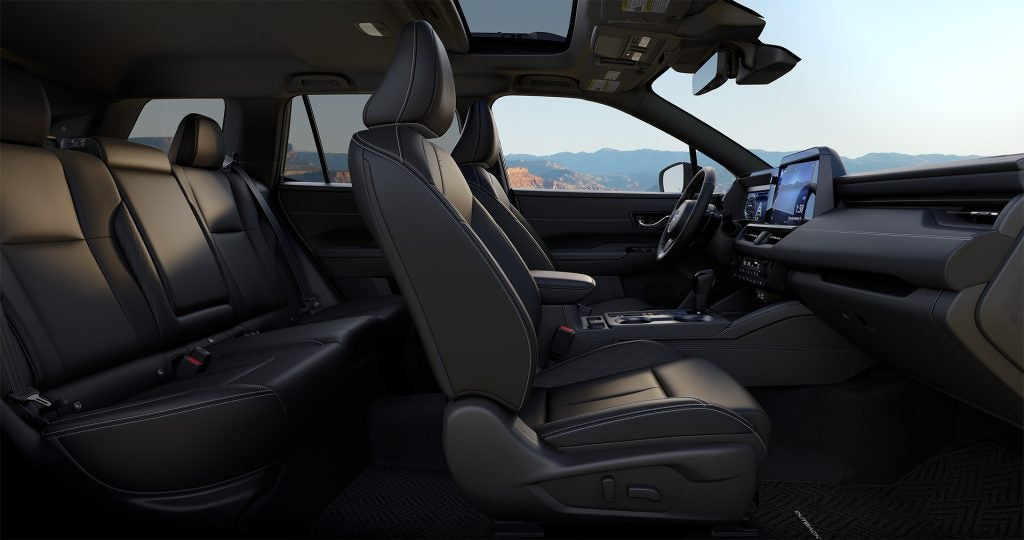 Interior view of a car with black leather seats and a digital dashboard